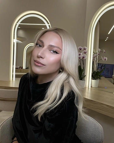 Woman holding her hair back showing off her makeup